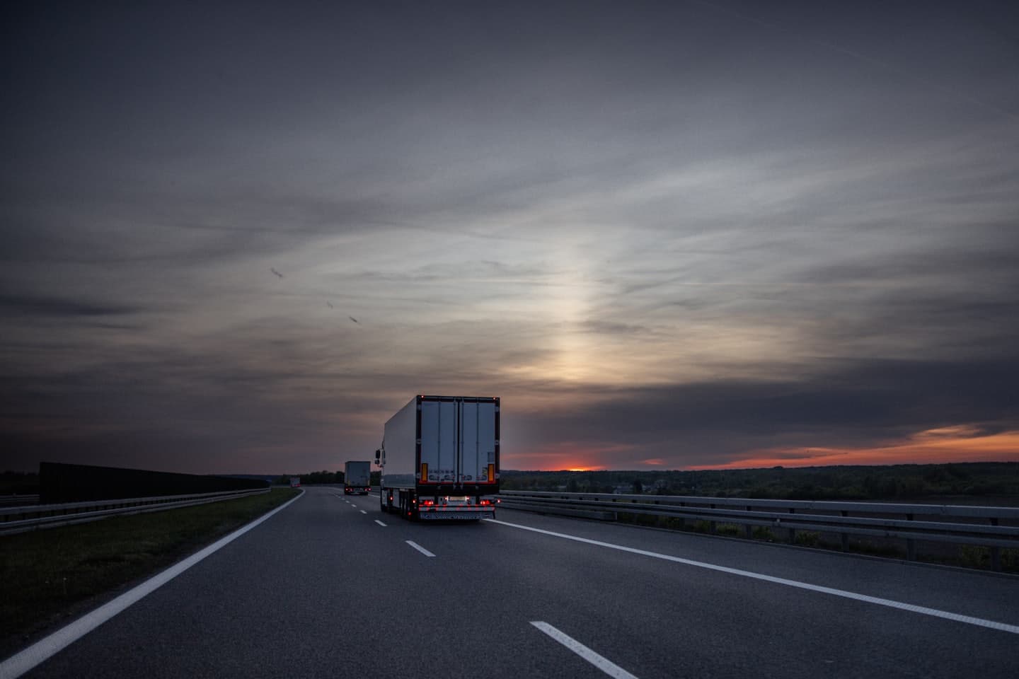 NAVI Cargo trucks running the interstate at sunset